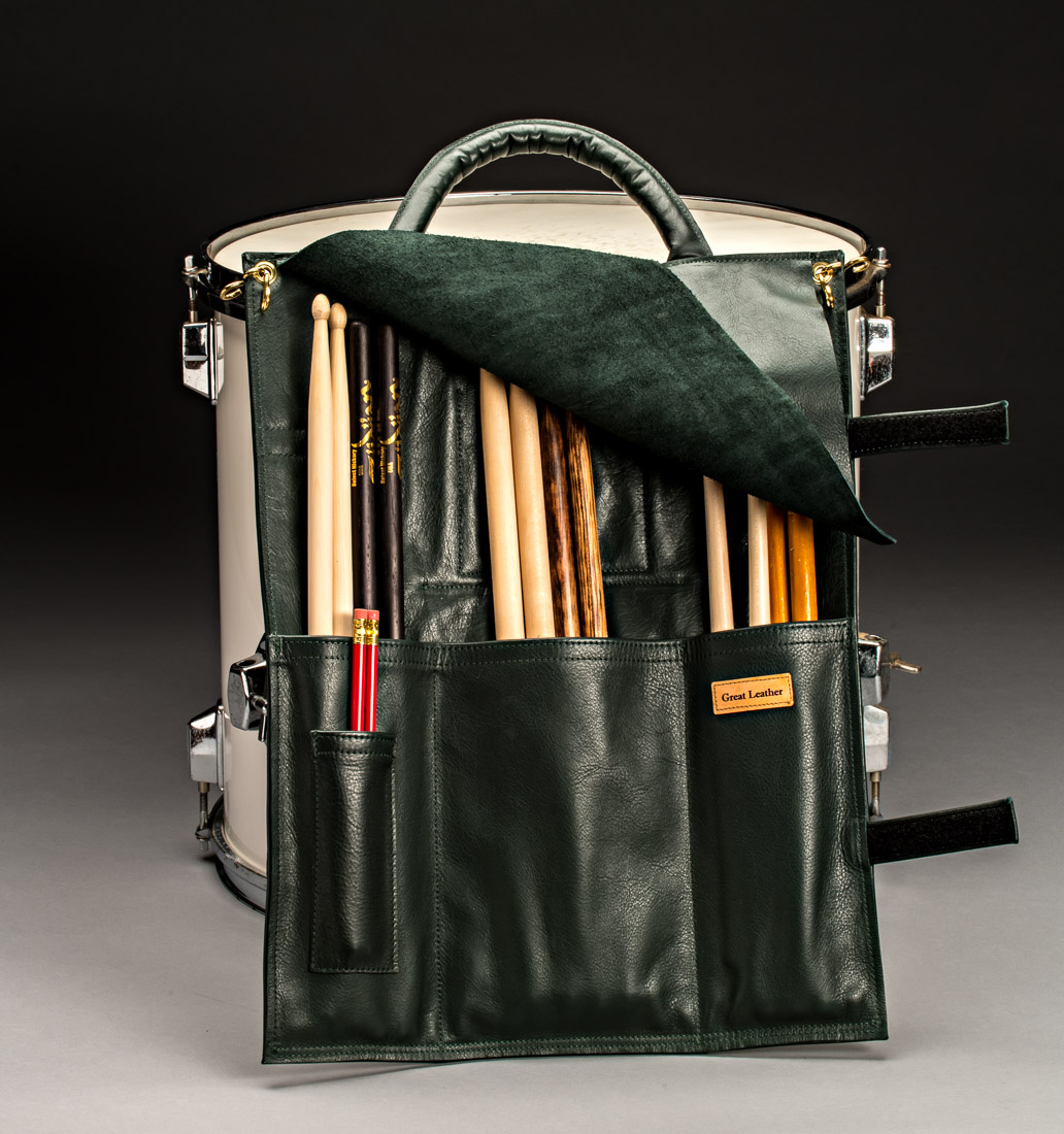 The flap that secures the drumsticks when closed, flips to the back pulling the leather carry handle down, creating a cushion for the drum and sticks. This is a one-of-a-kind design only from Great Leather. When ready to close the Great Leather Drumstick Bag, the drumsticks in the large inside pocket will be protected and held in by the flap. Then our unique velcro straps cinch the drummers valuable accessories in tight.